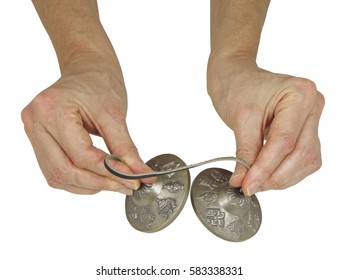 Holding Tibetan Ting Sha Ceremonial Bells - female hands holding a pair of Ting Sha percussion bells isolated on a white background