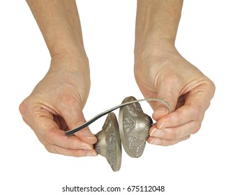 Holding Tibetan Ting Sha Ceremonial Bells - female hands holding a pair of Ting Sha percussion bells isolated on a white background
