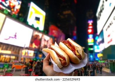 Holding two hot dogs in NYC on the Times Square - Powered by Shutterstock