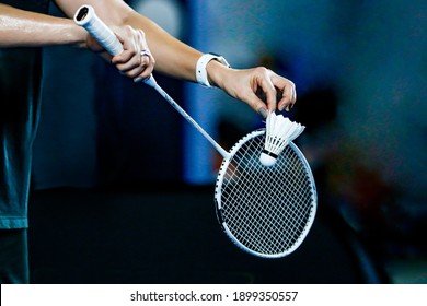 holding a white badminton racket ready to hit the ball