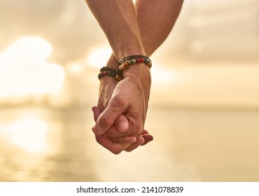 Holding your hand while we wonder the beach. Closeup shot of an unrecognizable couple holding hands while spending the day by the beach. - Powered by Shutterstock