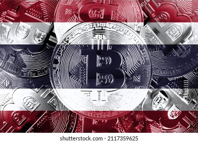Holds a physical version of Bitcoin and the Thai flag. Concept map of cryptocurrencies and blockchain technology in Thailand. Double exposure creative bitcoin symbol hologram. 