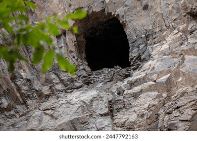 A hole in the bedrock wall resembles a cave. Ashabi-Kahf in Nakhchivan. - Powered by Shutterstock