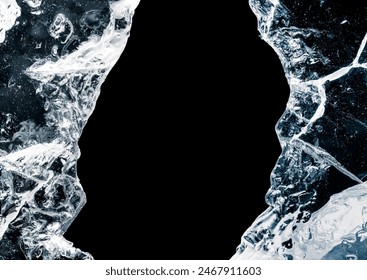 Hole, broken in a pure transparent crushed ice with cracks on a black background, close-up.
