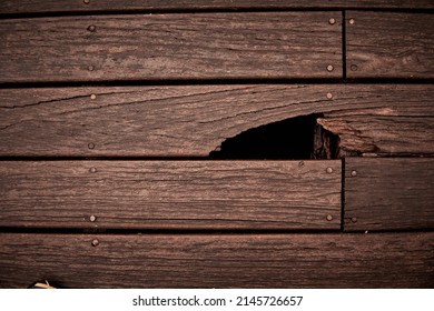 Hole In Brown Wooden Wall Or Floor. Damage, Broken Wood Surface. Horizontal