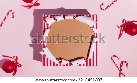 Hole in christmas gift box, empty space for advertising text in torn paper, background texture. High quality photo