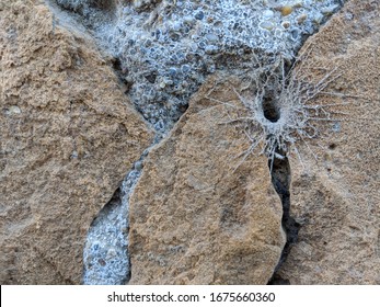 Hole With Cobweb On The Ocher Stone Wall