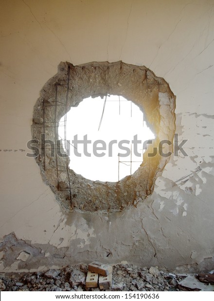 Hole in the concrete wall from tank shell with isolated\
space 