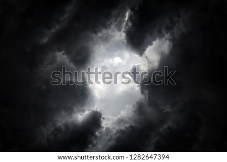 Hole in the Dark and Dramatic Storm Clouds