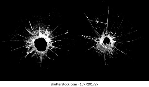 hole in the glass with cracks isolated on a black background