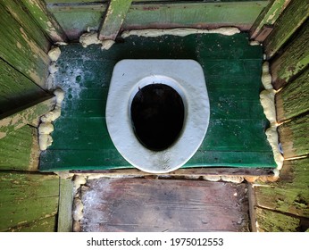 Hole of an old dirty country toilet, rural toilet inside, top view