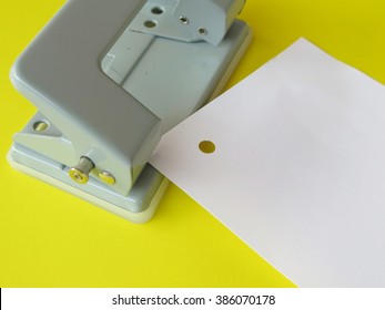 Hole Punched Paper In Office On Yellow Background