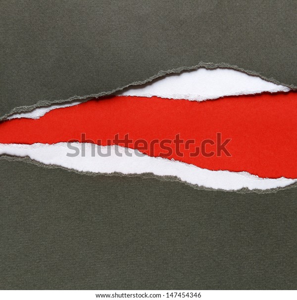 Hole ripped in paper on\
red background
