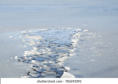 
Hole In The Thin Ice. Someone Fell Through The Ice. Dangerous Concept. Freezing And Melting Time For Ice On The Water Reservoirs In Winter.