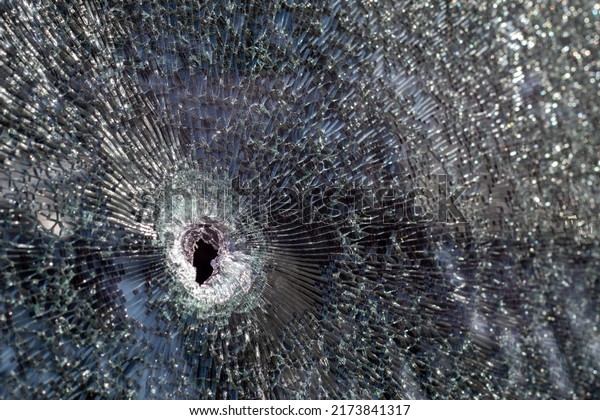 Holes on the windshield of the car, it was\
shot from a firearm. Bullet holes. Smash car windshield, broken and\
damaged car. Ukraine, Irpin - May 12,\
2022