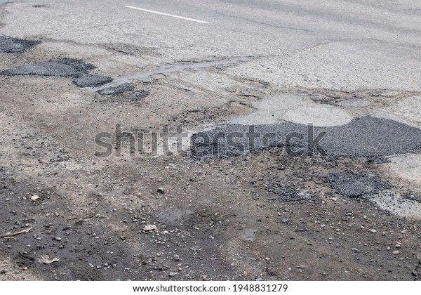 The holes in the\
road are filled with stones