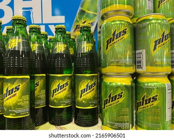 Holetown, Barbados - May 23, 2022: Glass Bottles And Cans Of Plus Power Up Energy Drink On Display On A Grocery Store Shelf. Plus Is Made By Banks Barbados Breweries Ltd