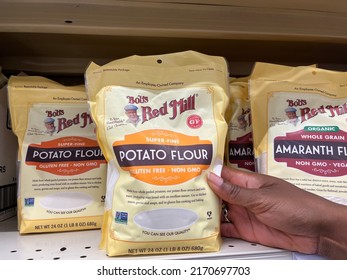 Holetown, Barbados - May 23, 2022: A Black Person Reaching For A Bag Of Bob's Red Mill Potato Flour On Display On A Grocery Store Shelf