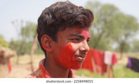 Holi celebrations Indian little boy playing Holi and showing face expression. - Shutterstock ID 2258498015