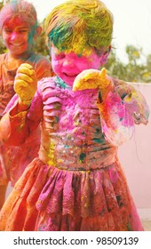 Holi Celebrations - Two Indian Kids Playing Holi In India.