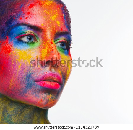 Holi colors festival. Portrait of beauty model with colorful powder art make on white studio background. Beautiful woman with rainbow makeup, copy space