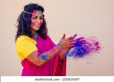 Holi Festival Of Colours. Portrait Of Happy Indian Girl In Traditional Hindu Sari On Holi Color . India Woman Silver Jewelry With Powder Paint On Dress ,colorful Pink And Blue Hair In Goa Kerala