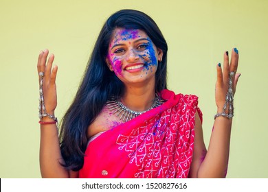 Holi Festival Of Colours. Portrait Of Happy Indian Girl In Traditional Hindu Sari On Holi Color . India Woman Silver Jewelry With Powder Paint On Dress ,colorful Pink And Blue Hair In Goa Kerala