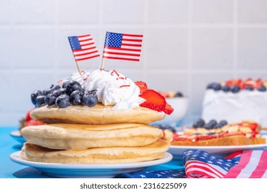 Holiday 4th of July breakfast pancakes, battercakes with whipped cream and berries like american flag. Homemade Patriotic sweet brunch or snack food, idea for party treat and desserts - Powered by Shutterstock