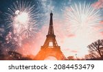 Holiday background - Eiffel tower with fireworks, celebration of the New Year in Paris, France