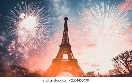 Holiday background - Eiffel tower with fireworks, celebration of the New Year in Paris, France