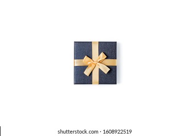 Holiday Card. Grey Gift Box With Gold Bow On Isolated White Background. Flat Lay, Top View, Copy Space.