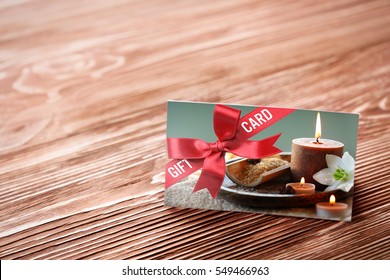 Holiday Celebration Concept. Spa Service Gift Card On Wooden Background