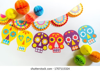 Holiday Cinco De Mayo Mexican. Decoration For The Festival. Garland Skull Painted With Patterns. Hands Of A Child.
