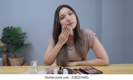 Holiday concept of 4k Resolution. Asian girl using facial oil control blotting paper at home.