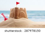 Holiday concept with sandcastle on the seaside