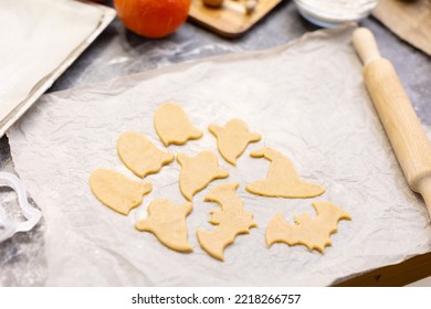 Holiday Cookies Cut Out Of Shortcrust Pastry For Baking In The Oven. Cookies Prepared For Baking In The Shape Of A Ghost, A Bat And A Witch's Hat. Baby Cookies, Background, Copy Space.