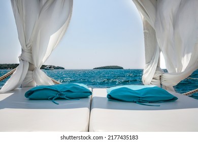 A Holiday Deckchair With An Empty Space Against The Background Of A Beautiful, Blue Sea