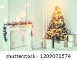 Holiday decorated room with Christmas tree and decoration, backgroound with blurred, sparking, glowing light. Happy New Year and Xmas theme, toning