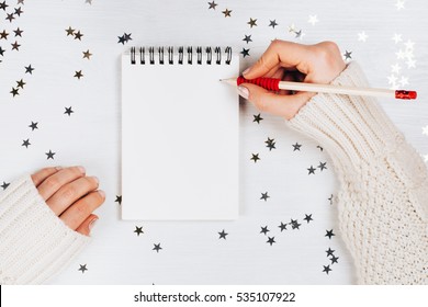 Holiday Decorations And Notebook With Wish List On White Rustic Table, Flat Lay Style. Planning Concept.