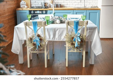 Holiday dining table is elegantly arranged with green glassware, woven placemats and white plates, creating warm and inviting setting on modern kitchen background. Christmas and New Year celebration - Powered by Shutterstock