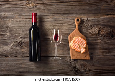 Holiday Dinner setting with red wine and creaming cheese on rustic wood. Top view with space for your greetings - Powered by Shutterstock