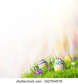 Holiday Easter Background With Eggs And Flowers In Grass. Celebratory Banner For Design