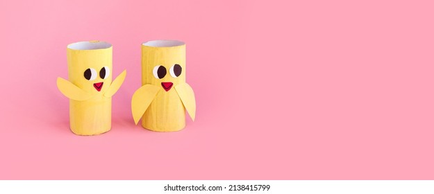 Holiday easy DIY craft idea for kids. Toilet paper roll tube toy chick baby on pink background. Creative Easter decoration eco-friendly, reuse, recycle, zero waste handmade minimal concept, banner - Shutterstock ID 2138415799