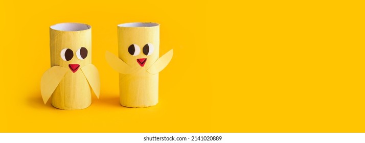 Holiday easy DIY craft idea for kids. Toilet paper roll tube toy chick baby on yellow background. Creative Easter decoration eco-friendly, reuse, recycle, zero waste handmade minimal concept, banner - Shutterstock ID 2141020889