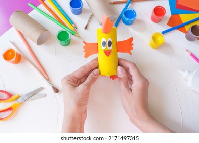 Holiday Easy DIY Craft Idea For Kids. Toilet Paper Roll Tube Toy Chick Baby On A White Background With Colored Paper.. Creative Easter Decoration Eco-friendly, Reuse, Recycle, Zero Waste Handmade