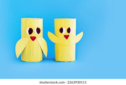 Holiday easy DIY craft idea for kids. Toilet paper roll tube toy's cute chick on blue background. Creative Easter, Christmas decoration eco-friendly, reuse, recycle handmade minimal concept - Shutterstock ID 2263930111