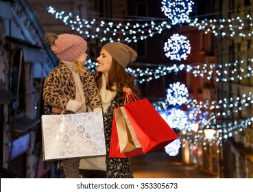 Holiday Family Trip To Venice, Italy Can Change The Whole Christmas Experience. Happy Mother And Child With Shopping Bags On Rialto Bridge In The Evening Among Christmas Lights