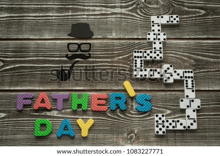 holiday father's day, dominoes on a wooden background. men's leisure, entertainment