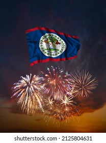 Holiday fireworks in evening sky and flag of Belize for National Independence day