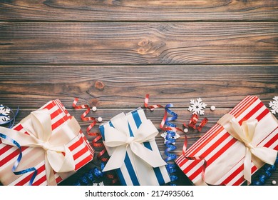 Holiday flat lay with gift boxes wrapped in colorful paper and tied decorated with confetti on colored background. Christmas, Birthday, Valentine and sale concept, top view. - Shutterstock ID 2174935061